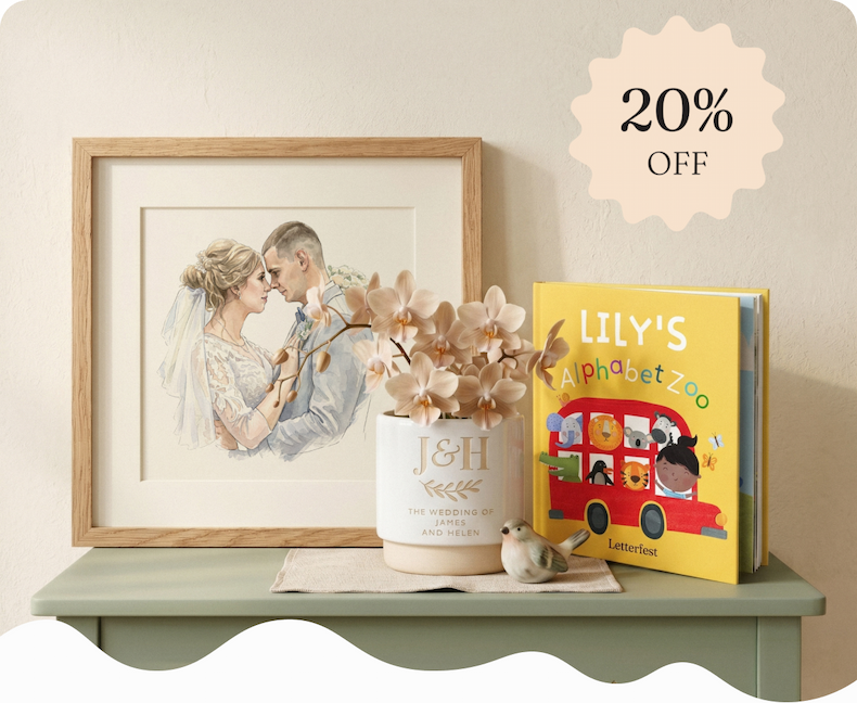 Display of personalised gifts including framed illustrations, a personalised book, wrapped presents, and an engraved plant pot on a shelf