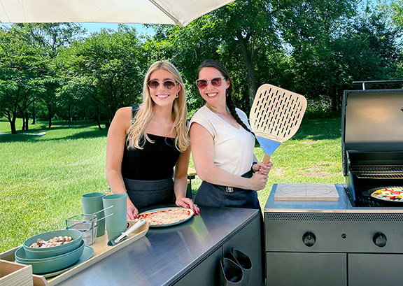 Two IKEA Co-Workers standing outside in a grilling area 