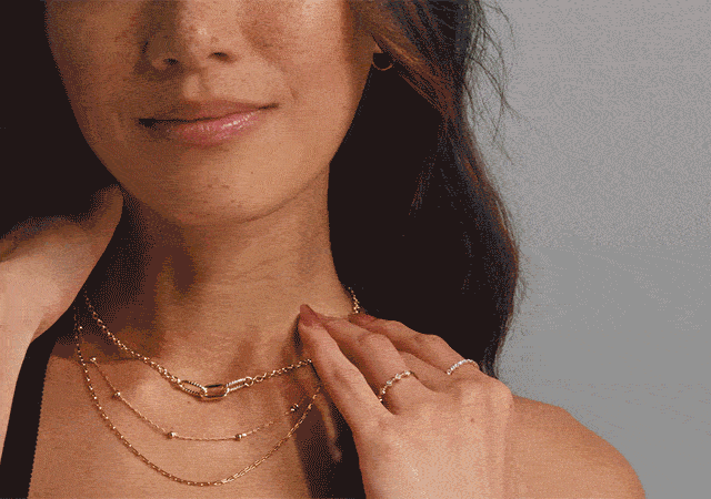 Close-up and lifestyle shots of a woman and man wearing yellow gold jewelry, including layered chains and necklaces, watch, dainty rings and hoop earrings.