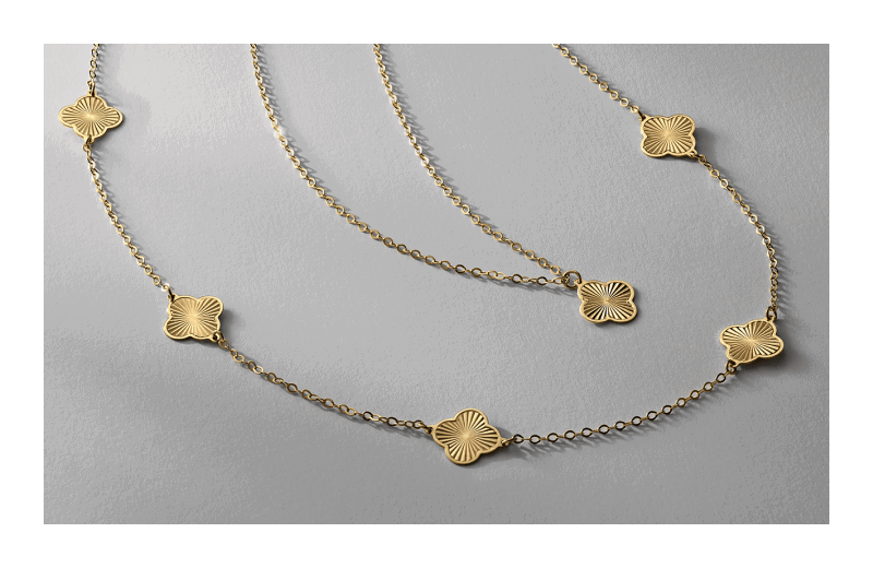 Two yellow gold necklaces featuring clover-shaped charms on delicate chains.