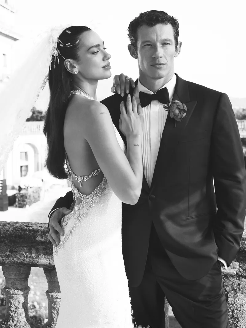 Image may contain: Callum Turner, Dua Lipa, Clothing, Formal Wear, Suit, Dress, Tuxedo, Face, Head, Person, and Photography