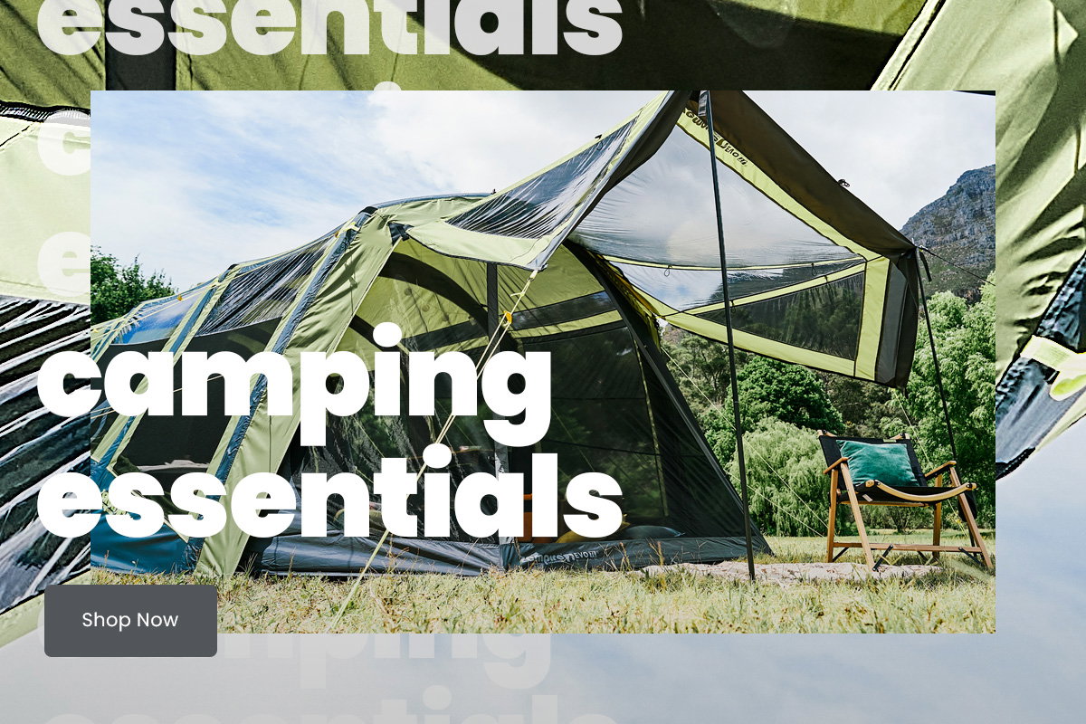 Green multi-room camping tent pitched on grassy ground with mesh panels and an extended canopy, set against a sunny hillside landscape with trees and mountains in the background. A folding camping chair sits to the right of the tent. Large overlaid text reads “Camping essentials.”