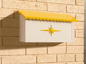 A Cinderella Ranch bright yellow mailbox.