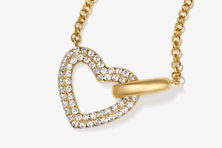 Yellow gold open heart-link pendant with pavé diamond details on dainty chain.