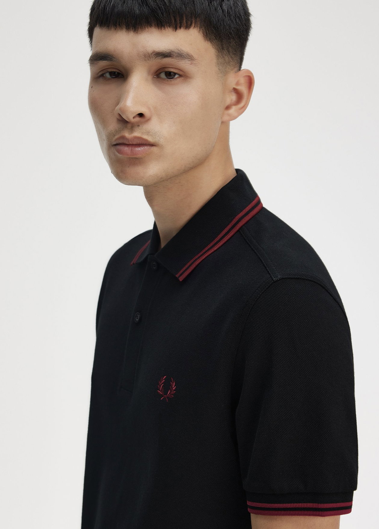 Male model wearing a Fred Perry M3600 Twin Tipped Shirt in Black / Burnt Red / Burnt Red