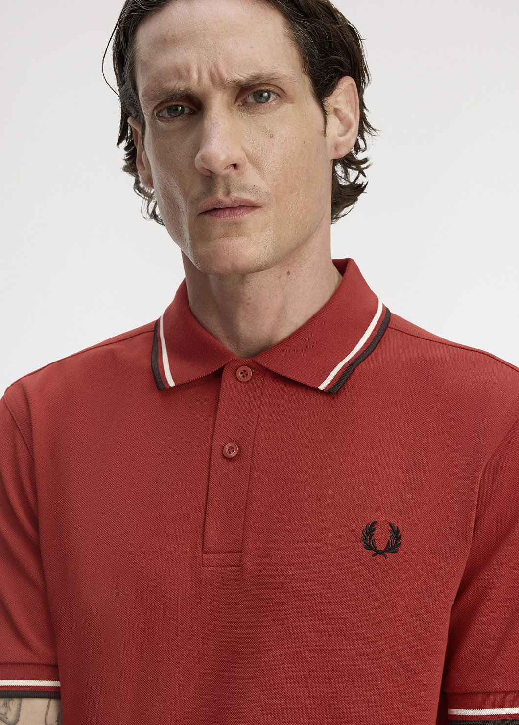 Male model wearing a Fred Perry M3600 Twin Tipped Shirt in Burnt Red