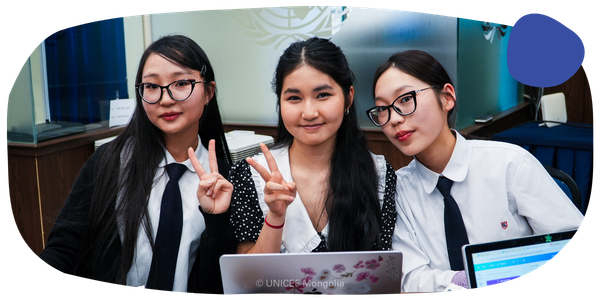 Three young females smiling at the camera. 