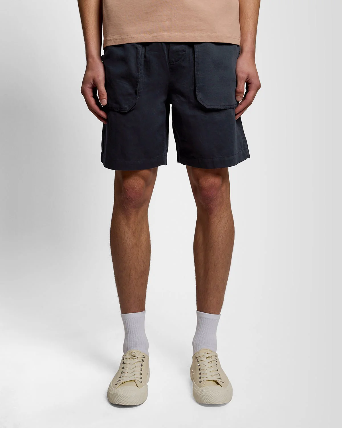 Man wears Linen Blend Shorts in Dark Navy