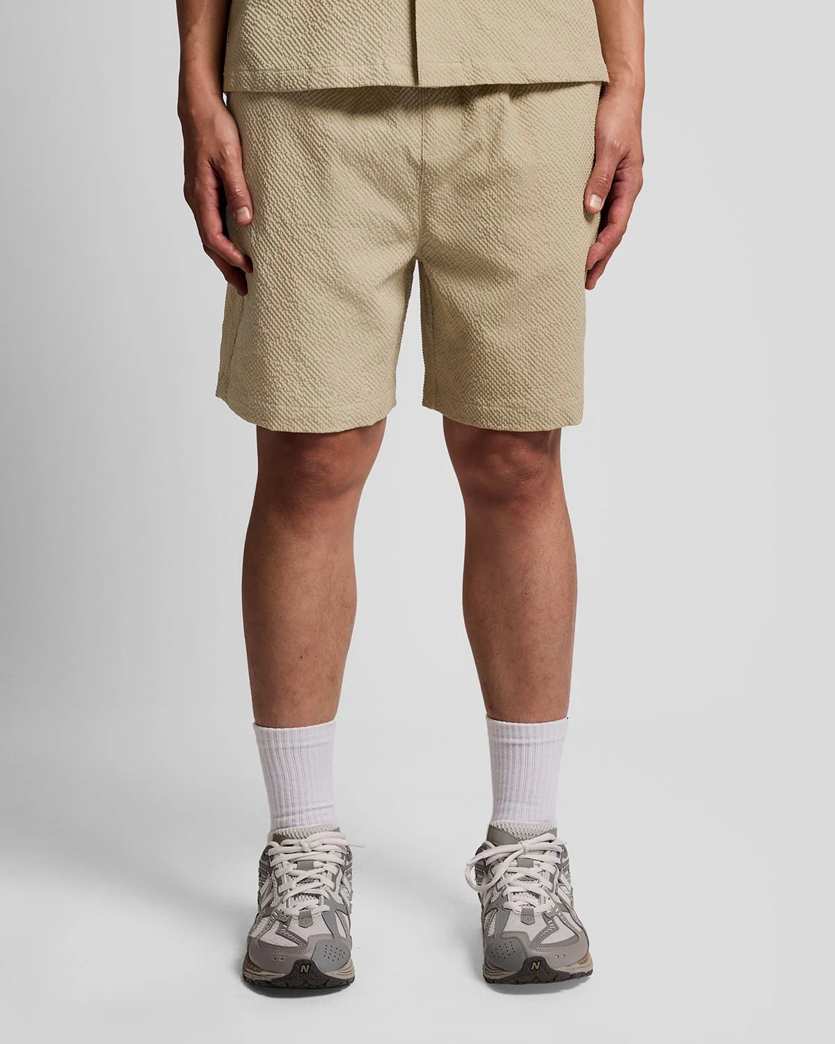 Man wears Textured Resort Shorts in Savona Clay