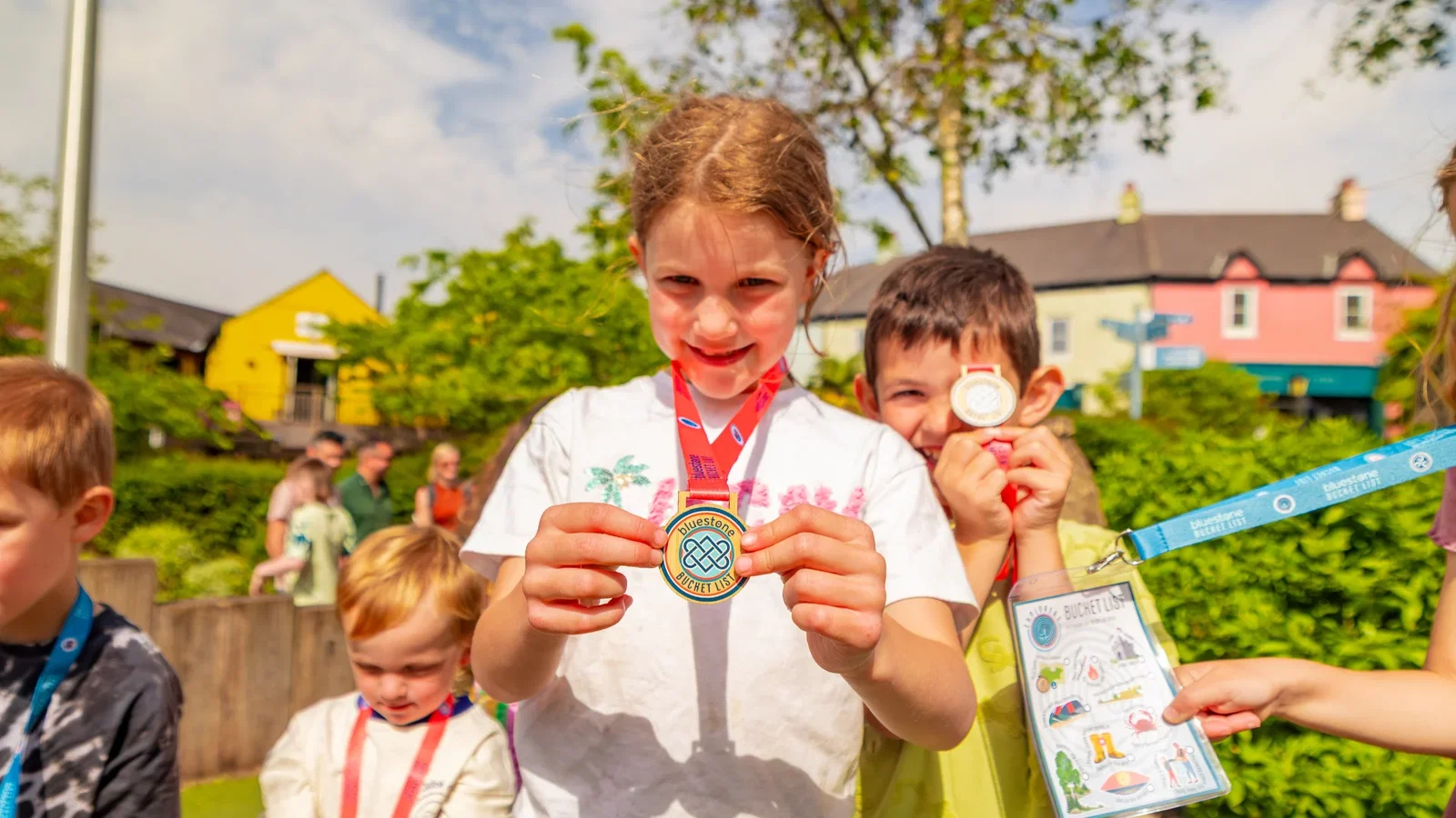 Girl showing off her bucket list medal
