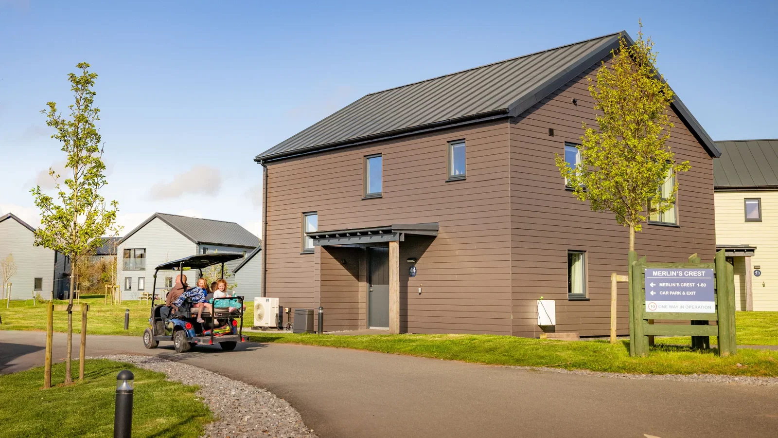 Family driving through Bluestone's platinum lodges on a sunny summers day