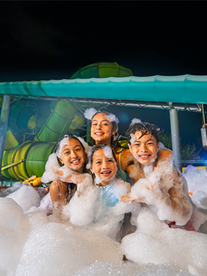 A group of friends enjoying the AquaGlow Event at Adventure Island