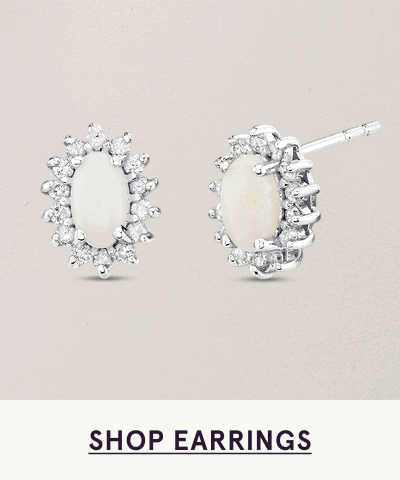 Silver studs with oval white-center stone surrounded by diamond halo. Click here to shop earrings