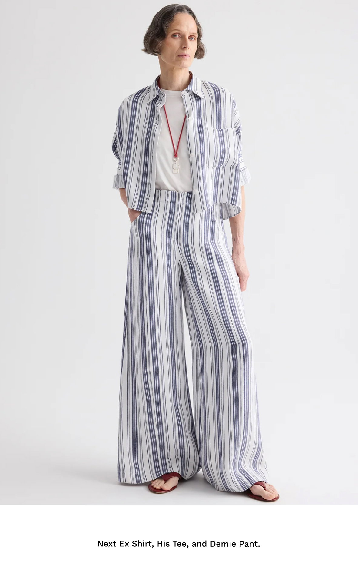 Image of a model in a blue and white striped outfit followed by black text beneath.