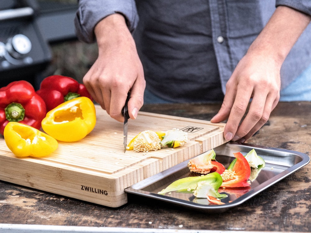 Hidden stainless-steel tray for prep, scraps, or serving