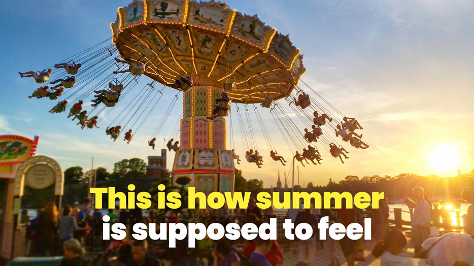 This is how summer is supposed to feel. People riding a swing carousel at an outdoor amusement park at sunset 