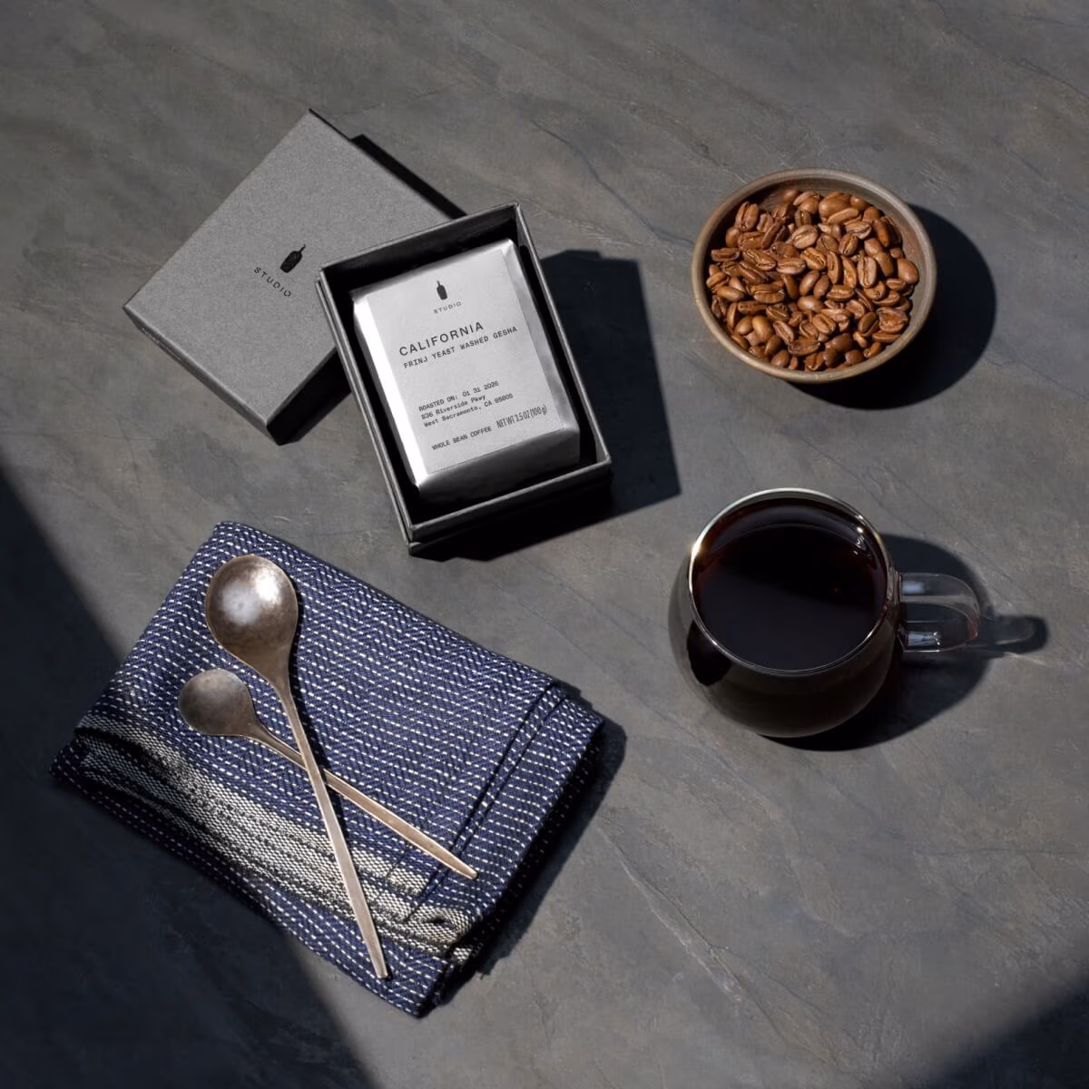 Coffee bag, coffee beans and coffee cup.