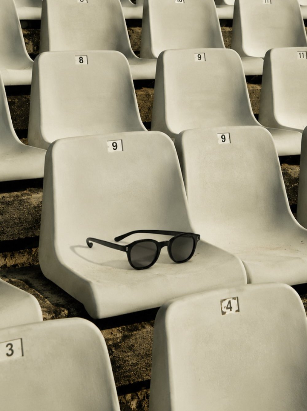 Sport bleachers with the William Sunglasses displayed on one of the seats