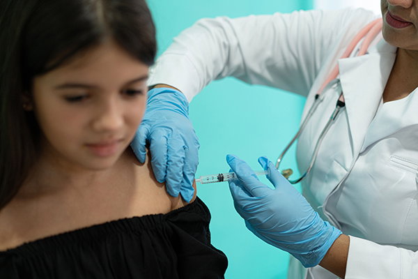 A vaccine being administered to a girl.
