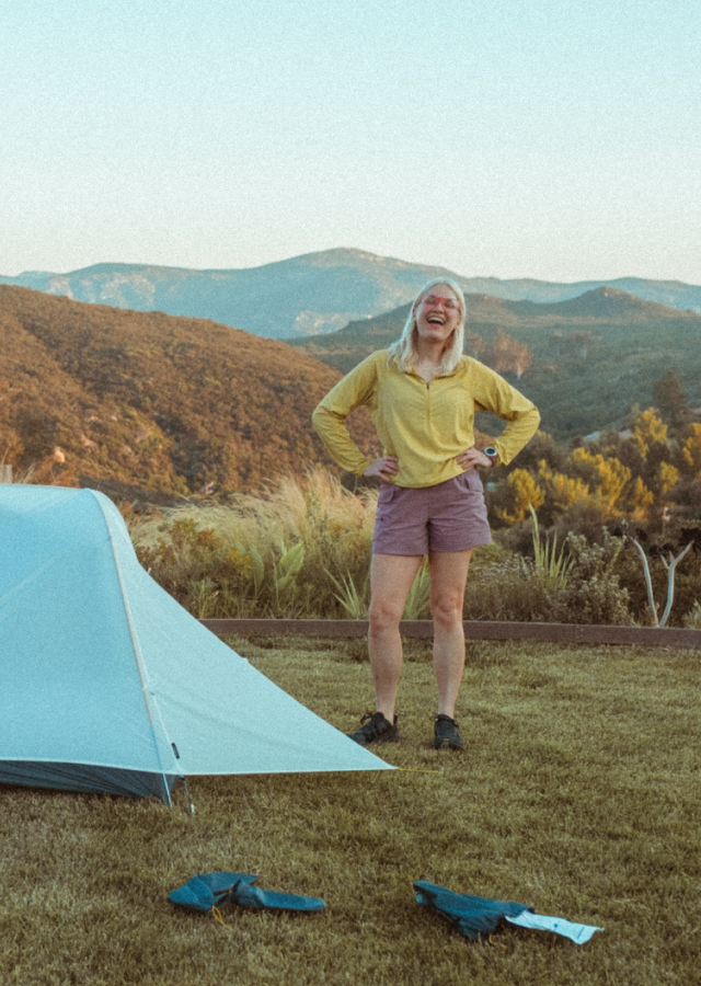 Liz setting up her tent in the Sunshield™ Hoody.