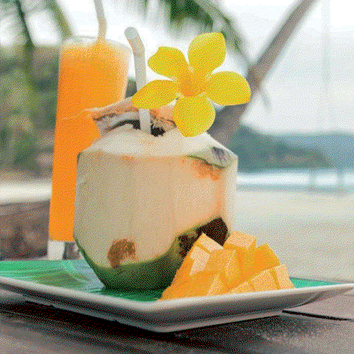 A coconut drink with fruit.