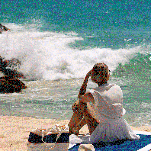 Woman lounging on the beach.