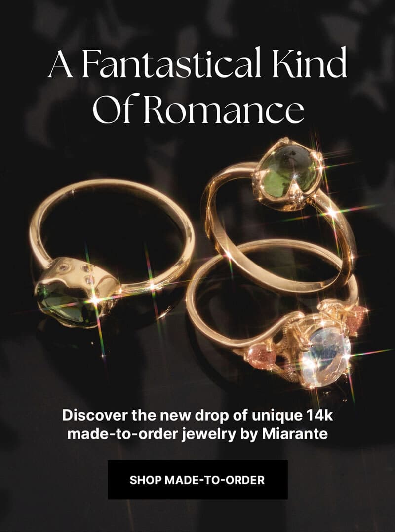 two beautiful stunning 14k solid gold made-to-order rings from Miarante featuring real gemstones that are sparkling against a dark colored background