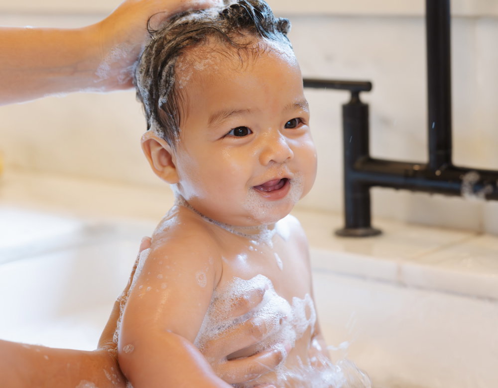 baby in tub with sudsy bubbles