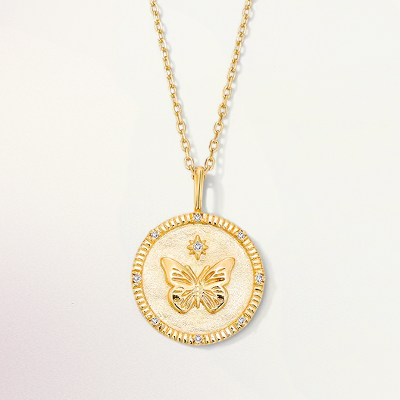 A gold necklace with a butterfly medallion.