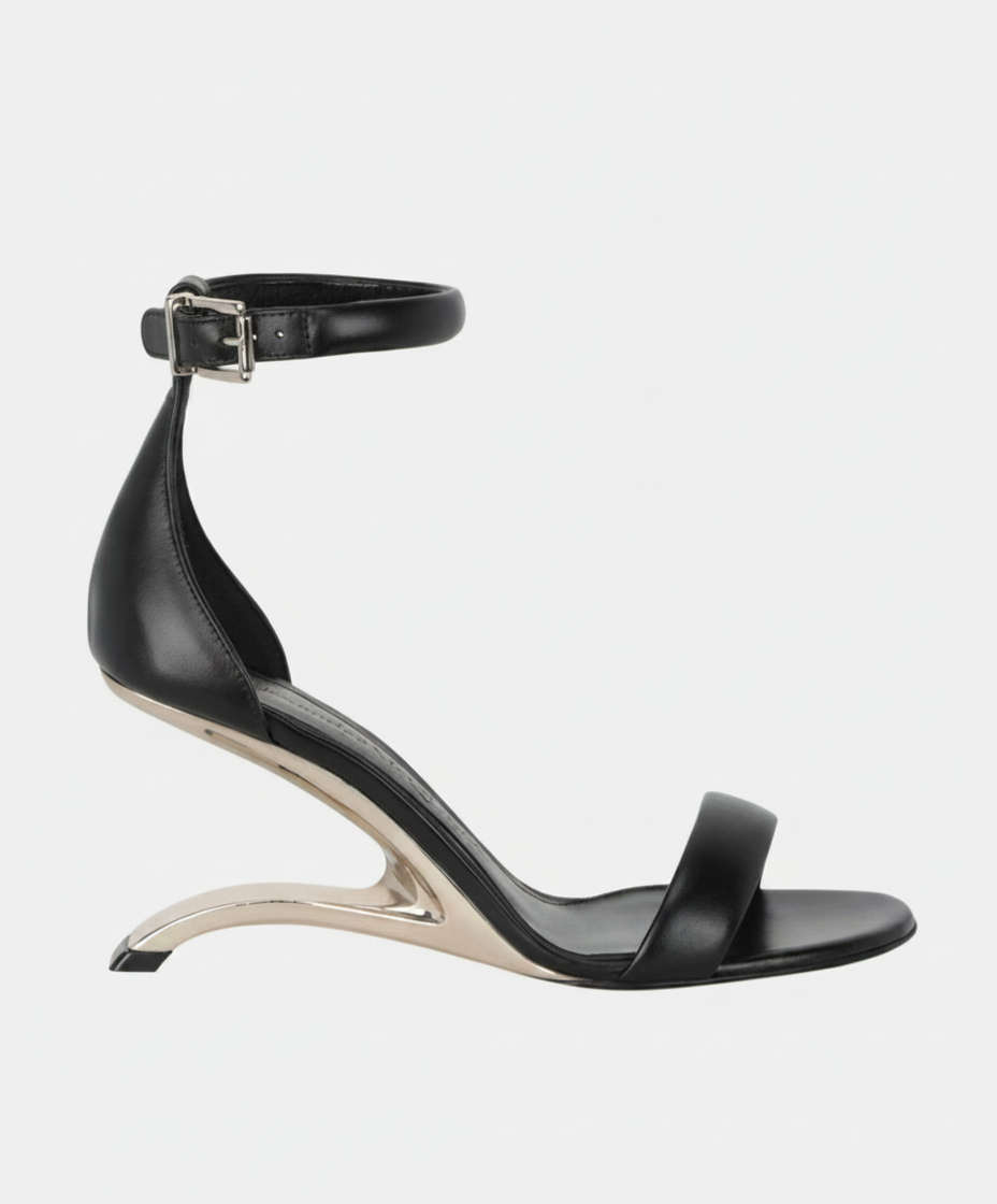 Black leather sandal with a metallic sculpted heel and ankle strap.