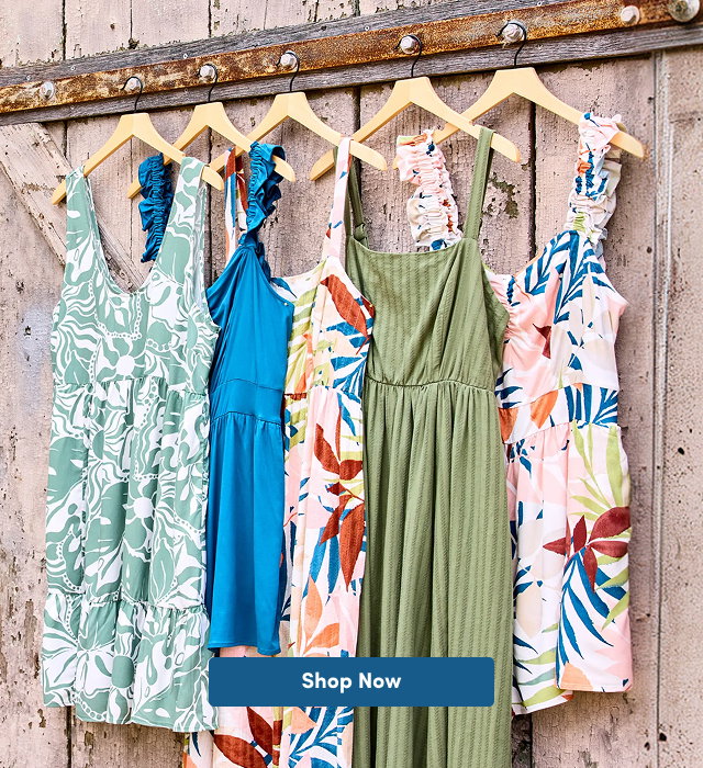 5 dresses on hangers. Shop Now >