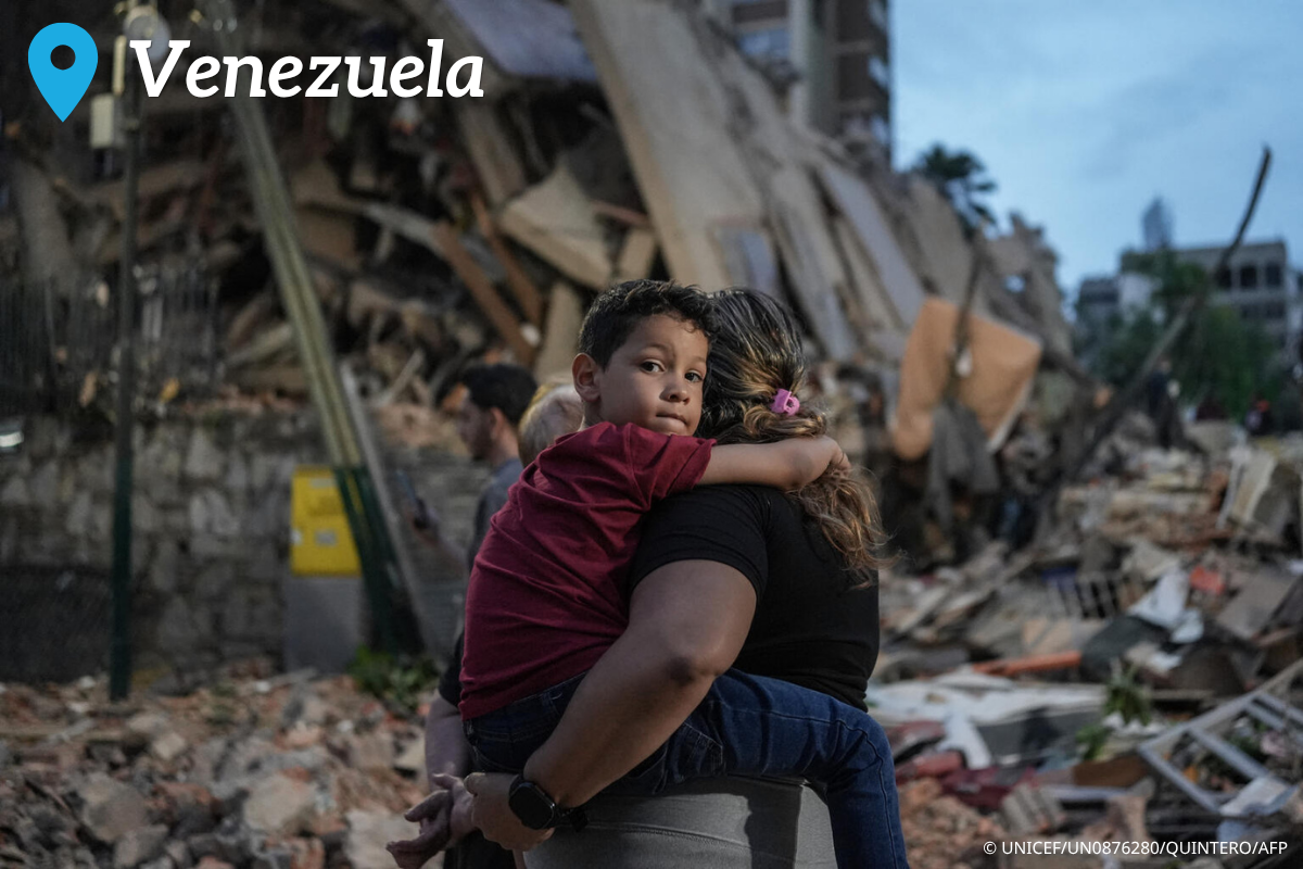 People walk past a collapsed building following an earthquake in Caracas on June 25, 2026.