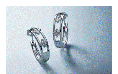 GIF featuring hoops with diamond floral accents. Yellow gold bangle bracelets. Charm necklaces and gemstone rings.