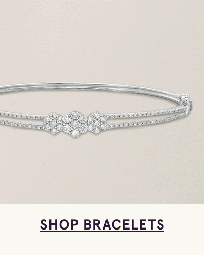 Split-band design silver bangle with three interconnected, diamond-encrusted clusters. Click here to shop bracelets