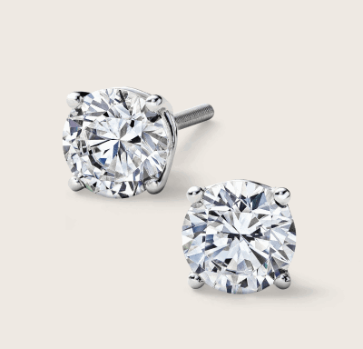 White gold diamond stud earrings in four-prong settings.