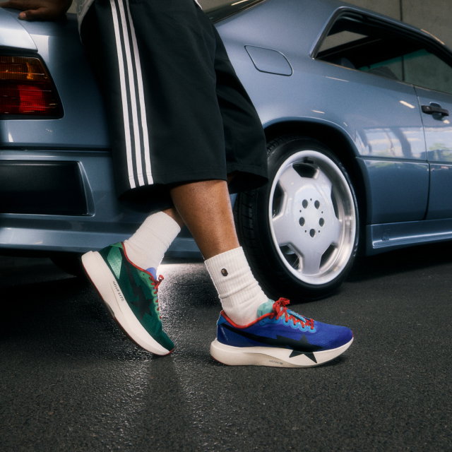Low-body crop of a model wearing the Home Edition adidas Originals x BAPE EVO SL shoes.