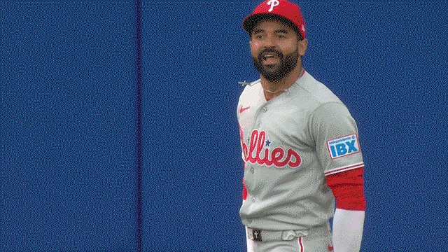 An animated gif of Phillies center fielder Derek Hill bouncing and nodding his head in celebration