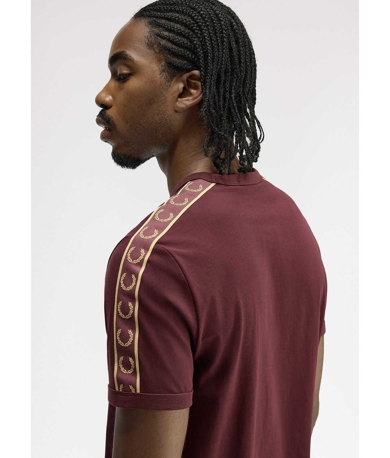 Male model wearing a Fred Perry Contrast Tape Ringer T-Shirt in Oxblood / Champagne