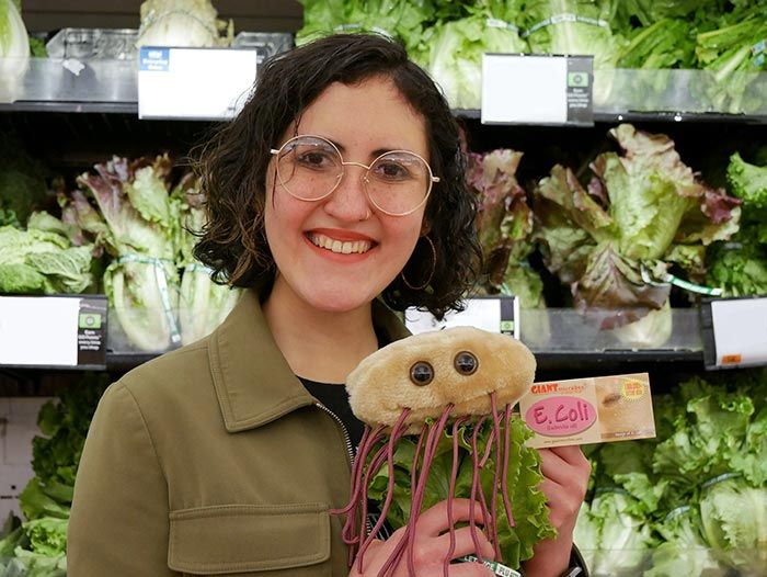 Model holding E. coli plush
