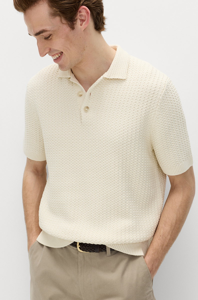 Man wearing an Ecru Pure Cotton Textured Knitted Polo Shirt and Putty Loose Fit Stretch Chinos