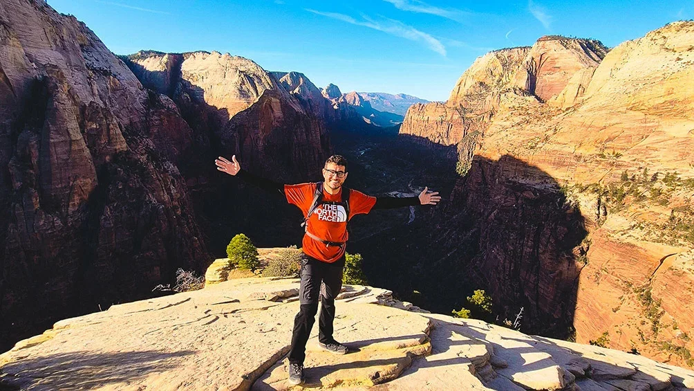 Image description: Man hiking Angel’s Landing at Zion National Park.

