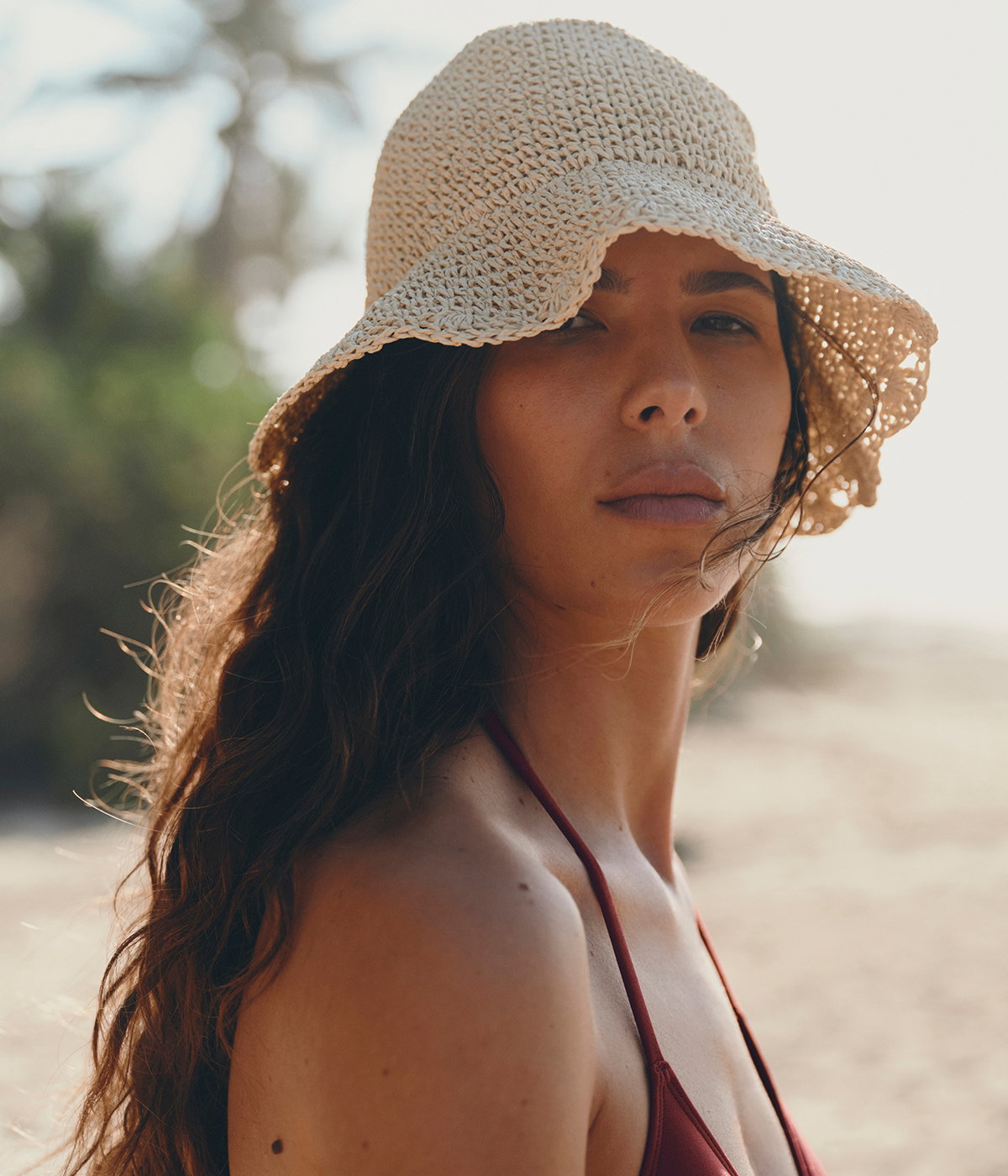 Close up of model wearing a straw hat