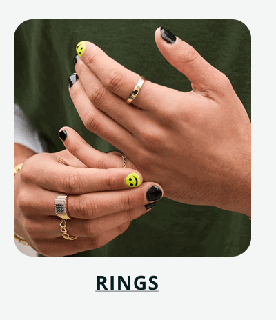 Smiley-face nail art with gold band & signet rings on hand. Click here to shop rings