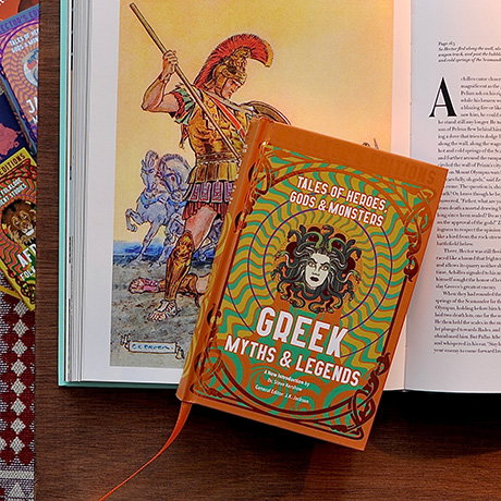Collector's edition of Greek Myths and Legends displayed on an open illustrated book on a desk. - Books Collection.