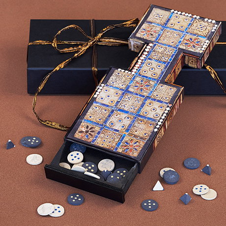 Playable set of The Royal Game of Ur with textured board and pieces displayed on a gift box. - Games and Puzzles.