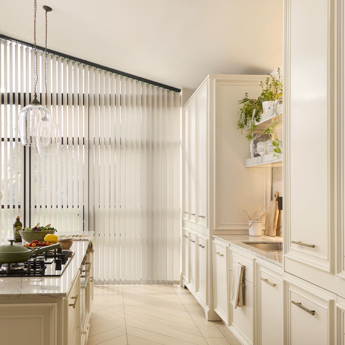 Floor-to-ceiling white vertical blinds tailored to a large, angled sloping kitchen window
