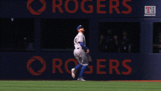 An animated gif of Brandon Nimmo crashing into the wall on a leaping catch