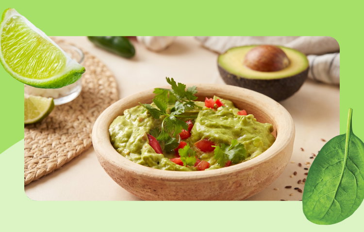 A vibrant bowl of creamy guacamole is paired with fresh ingredients like avocado, lime, and herbs, making it a simple, crowd-pleasing addition to any gathering or summer spread.