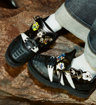 Close-up of a model wearing shoes from the new adidas Originals x Brain Dead by Disney collection.
