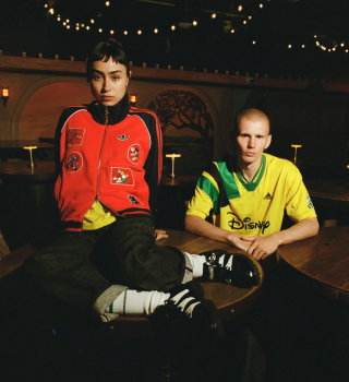 Two models wearing apparel from the new adidas Originals x Brain Dead by Disney collection.